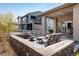 Backyard featuring an outdoor seating area with a stone fire pit and furniture at 16392 Spanish Peak Way, Broomfield, CO 80023