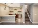 Finished basement bar features wood shelves, pendant lights, and stainless steel dishwasher at 16392 Spanish Peak Way, Broomfield, CO 80023