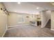 Spacious carpeted basement with a window and a bar area with bar stools and stairs to the upper level at 16392 Spanish Peak Way, Broomfield, CO 80023
