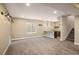 Spacious basement area with wet bar, carpeted floors, recessed lights, and large window at 16392 Spanish Peak Way, Broomfield, CO 80023