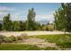 Community basketball court with mountain views and lush trees at 16392 Spanish Peak Way, Broomfield, CO 80023