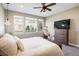 Bright bedroom features a ceiling fan, carpet flooring, and three windows overlooking the property at 16392 Spanish Peak Way, Broomfield, CO 80023