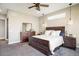 Bright bedroom features a ceiling fan, carpet flooring, and a rustic wood bed frame with matching dressers at 16392 Spanish Peak Way, Broomfield, CO 80023