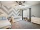 Bright bedroom featuring a daybed, dresser, ceiling fan, and a window with curtains and natural light at 16392 Spanish Peak Way, Broomfield, CO 80023
