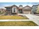 Beautifully landscaped two-story home with stone accents and a well-manicured lawn at 16392 Spanish Peak Way, Broomfield, CO 80023
