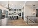 Modern kitchen with an island, bar stool seating, pendant lighting, and stainless steel appliances at 16392 Spanish Peak Way, Broomfield, CO 80023