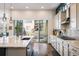 Open kitchen featuring stainless appliances, and a view of the outdoor patio at 16392 Spanish Peak Way, Broomfield, CO 80023