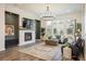 Inviting living room with a cozy fireplace, modern lighting, and stylish decor at 16392 Spanish Peak Way, Broomfield, CO 80023