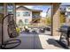 Covered patio with outdoor furniture, a hanging chair, a grill, and a view of the backyard at 16392 Spanish Peak Way, Broomfield, CO 80023
