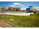 Community pool featuring water slides, a play area, and plenty of open space at 16392 Spanish Peak Way, Broomfield, CO 80023