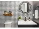 Powder room with stylish tile, modern accents and a floating shelf at 16392 Spanish Peak Way, Broomfield, CO 80023