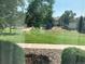 Backyard view from inside featuring green grass, trees, and adjacent buildings in the distance at 5455 S Dover S St # 102, Littleton, CO 80123