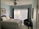 The bedroom features a comfortable bed with a quilt, a chair, and a large window at 5455 S Dover S St # 102, Littleton, CO 80123