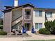 Inviting condo with colorful chairs and planters, enhanced by a quaint front porch and well-maintained landscaping at 5455 S Dover S St # 102, Littleton, CO 80123