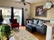 Inviting living room with comfortable seating, decorative rug, and access to a balcony at 5455 S Dover S St # 102, Littleton, CO 80123