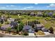 Lovely aerial view of neighborhood with mature landscaping and views of the Rocky Mountains at 1488 Baguette Dr, Castle Rock, CO 80108