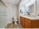 Bathroom featuring a double sink vanity, a shower with glass door and wood-look tile flooring at 1488 Baguette Dr, Castle Rock, CO 80108