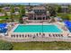 Community pool with lounge seating and well-maintained landscaping in aerial view at 1488 Baguette Dr, Castle Rock, CO 80108