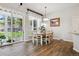 Cozy dining area with sliding glass doors, hardwood floors, and adjacent breakfast bar at 1488 Baguette Dr, Castle Rock, CO 80108