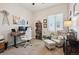Bright home office with a sit-stand desk, cozy armchair, and lots of natural light at 1488 Baguette Dr, Castle Rock, CO 80108