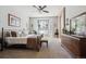 Spacious bedroom with a bay window, ceiling fan, and an antique vanity set against neutral walls and plush carpeting at 1488 Baguette Dr, Castle Rock, CO 80108