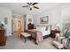 Bright bedroom featuring plush carpeting, a ceiling fan, and a comfortable sitting area, filled with natural light at 1488 Baguette Dr, Castle Rock, CO 80108