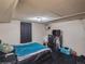 Cozy bedroom with dark carpet, black dresser, and comfy-looking bed with blue blanket at 300 S Simms St, Lakewood, CO 80228