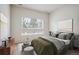 This bedroom features a calming color palette, a large window, and curated decor at 485 Interlocken Blvd # 102, Broomfield, CO 80021