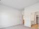 This bedroom features neutral walls, soft carpeting, and access to the bath and kitchen at 485 Interlocken Blvd # 102, Broomfield, CO 80021
