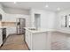 Spacious kitchen features white cabinets, stainless appliances and a center island at 485 Interlocken Blvd # 102, Broomfield, CO 80021