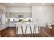 Bright kitchen features gray cabinets, stainless appliances, and an island with seating at 485 Interlocken Blvd # 102, Broomfield, CO 80021