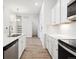 Modern kitchen with white cabinetry, stainless appliances, and an open layout at 485 Interlocken Blvd # 102, Broomfield, CO 80021