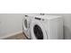 Bright laundry room featuring modern, energy-efficient washer and dryer at 485 Interlocken Blvd # 102, Broomfield, CO 80021