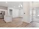 Open-concept living room with modern lighting and luxury vinyl plank flooring throughout at 485 Interlocken Blvd # 102, Broomfield, CO 80021