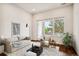 Comfortable living room with large windows, neutral colors and wood floors at 485 Interlocken Blvd # 102, Broomfield, CO 80021