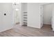 Open-concept living space with luxury vinyl plank flooring and built in shelving at 485 Interlocken Blvd # 102, Broomfield, CO 80021