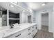 Bright bathroom with double sink vanity, marble countertop, and walk-in closet at 1963 Hogan Ct, Castle Rock, CO 80109