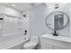 Contemporary bathroom with a modern vanity, round mirror, and shower-tub combination at 1963 Hogan Ct, Castle Rock, CO 80109