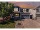 Charming two-story home with a well-maintained lawn, two-car garage, and covered front porch at 1963 Hogan Ct, Castle Rock, CO 80109