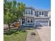 Charming two-story home boasts a covered porch, a well-maintained lawn, and a gray two-car garage at 1963 Hogan Ct, Castle Rock, CO 80109