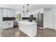 Modern kitchen with stainless steel appliances, a center island, and black backsplash at 1963 Hogan Ct, Castle Rock, CO 80109
