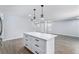 Spacious kitchen island with white countertop and black hardware, open to dining area at 1963 Hogan Ct, Castle Rock, CO 80109