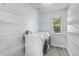 Functional laundry room with washer, dryer, and ample wire shelving for storage at 1963 Hogan Ct, Castle Rock, CO 80109