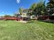 View of the back of the house, including a deck, brick patio and landscaped yard at 9535 W 104Th Ct, Broomfield, CO 80021