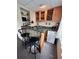 Basement bar area with glass-block detail, storage, wine rack, and black bar stools at 9535 W 104Th Ct, Broomfield, CO 80021