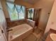 Bathroom boasts a soaking tub and a separate shower, illuminated by a window for natural light at 9535 W 104Th Ct, Broomfield, CO 80021