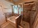 This bathroom features a combination tub and shower with tile surround and a window with views at 9535 W 104Th Ct, Broomfield, CO 80021