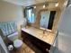 Bathroom features a stylish mirror, vanity with sink, and tiled floors that create a cozy and functional space at 9535 W 104Th Ct, Broomfield, CO 80021