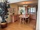 Bright dining room with hardwood floors, wooden table with six chairs, and a glass display cabinet at 9535 W 104Th Ct, Broomfield, CO 80021
