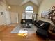 Comfortable living room area showcasing hardwood floors, high ceilings, and natural light coming from a large window at 9535 W 104Th Ct, Broomfield, CO 80021